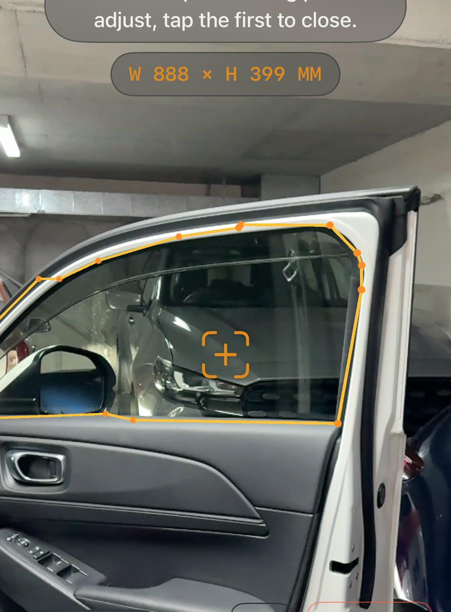 AR measuring app tracing a car window outline to exact dimensions