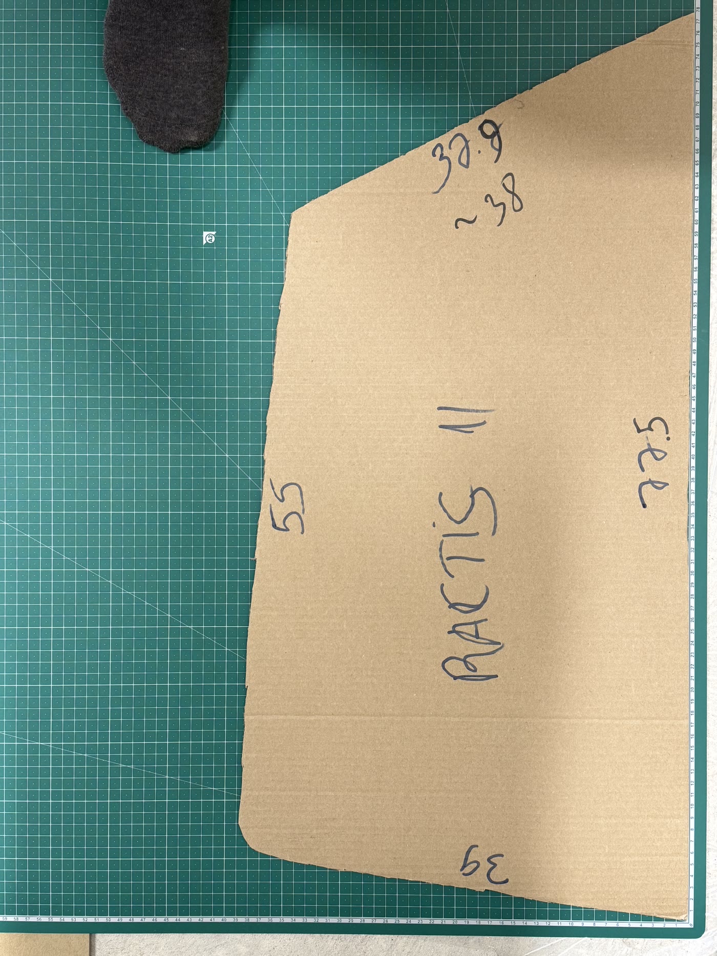 A hand-cut cardboard template of a specific vehicle's window