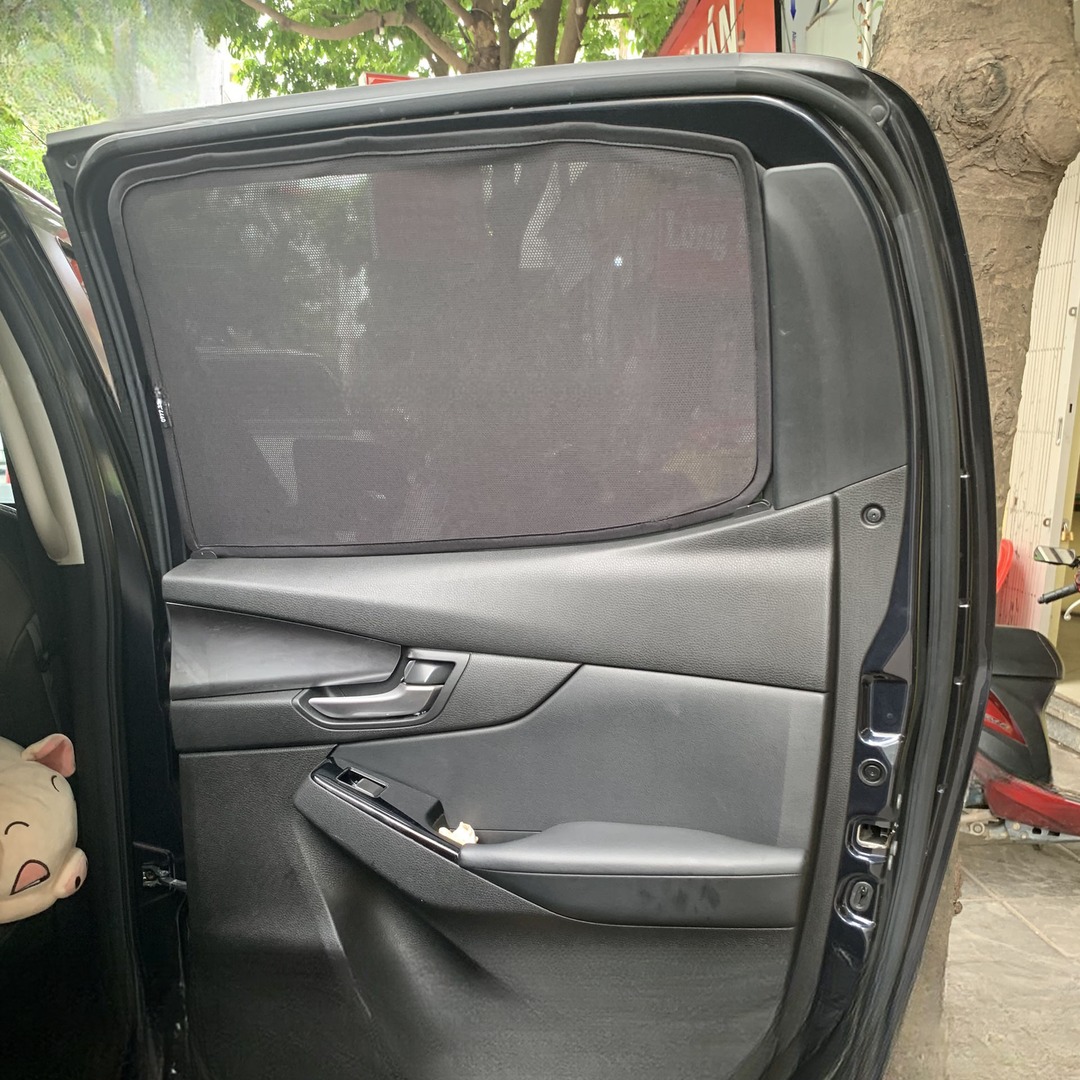 Rear door glass of a Mazda BT-50 dual cab with a shade fitted, viewed from inside the cab with the door open