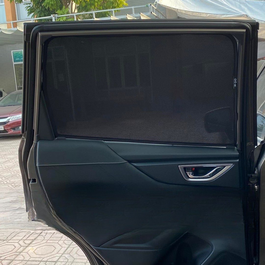 Two CarShade magnetic sun shades fitted to the rear door windows of a Subaru Forester, each panel filling its window edge to edge
