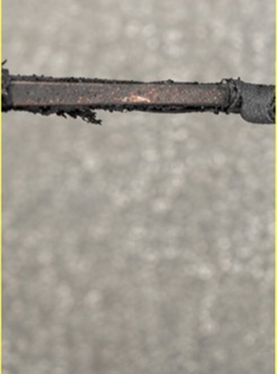 A flat steel wire that has cut its way out through the shade fabric